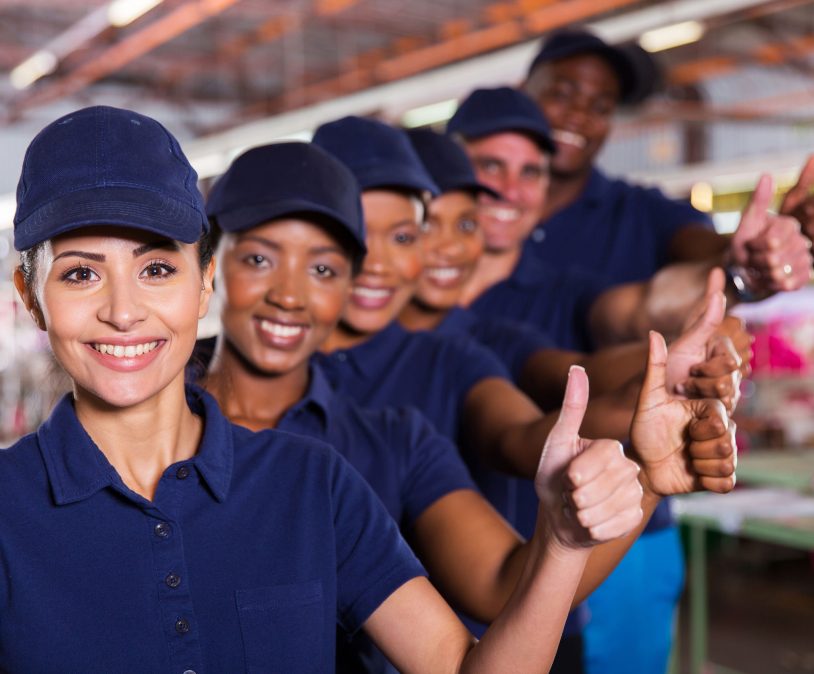 36871607 - cheerful textile workers team giving thumbs up